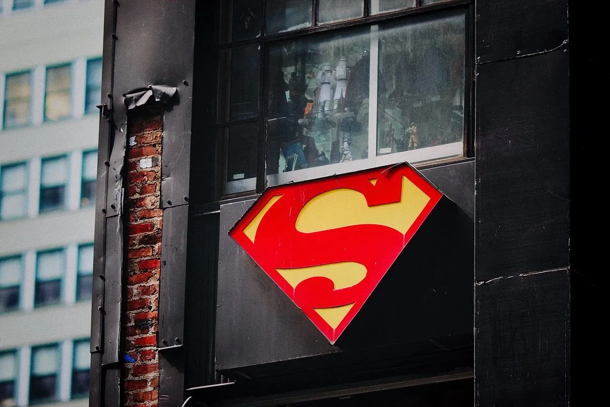 A Superman emblem on a dark building wall